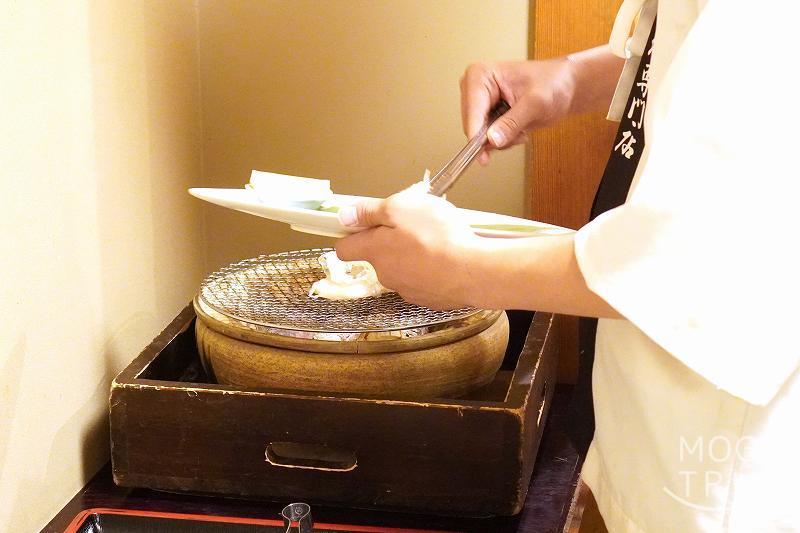 札幌「氷雪の門」タラバ蟹の抱身を火鉢で焼いている